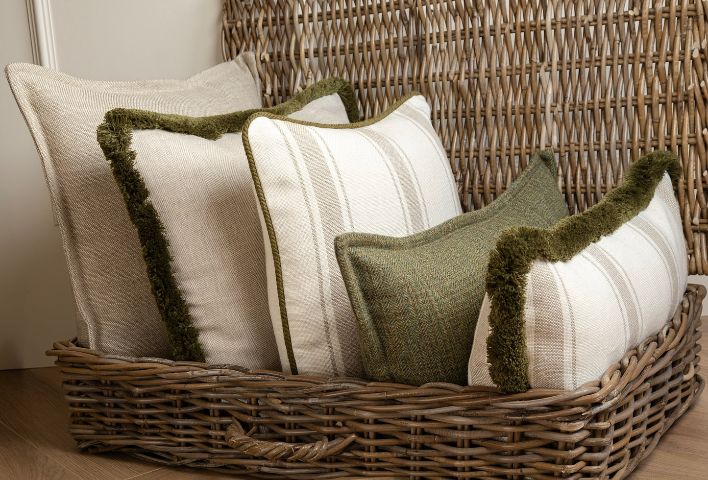 A collection of Green and Neutral cushions, featuring Olive green fringing and piping details. This image shows a variety of sizes, Square and Lumber Cushions. Made In Ireland. Fun aesthetically pleasing, High quality cushions made to last. Irish Linen, Irish Tweed Cushion