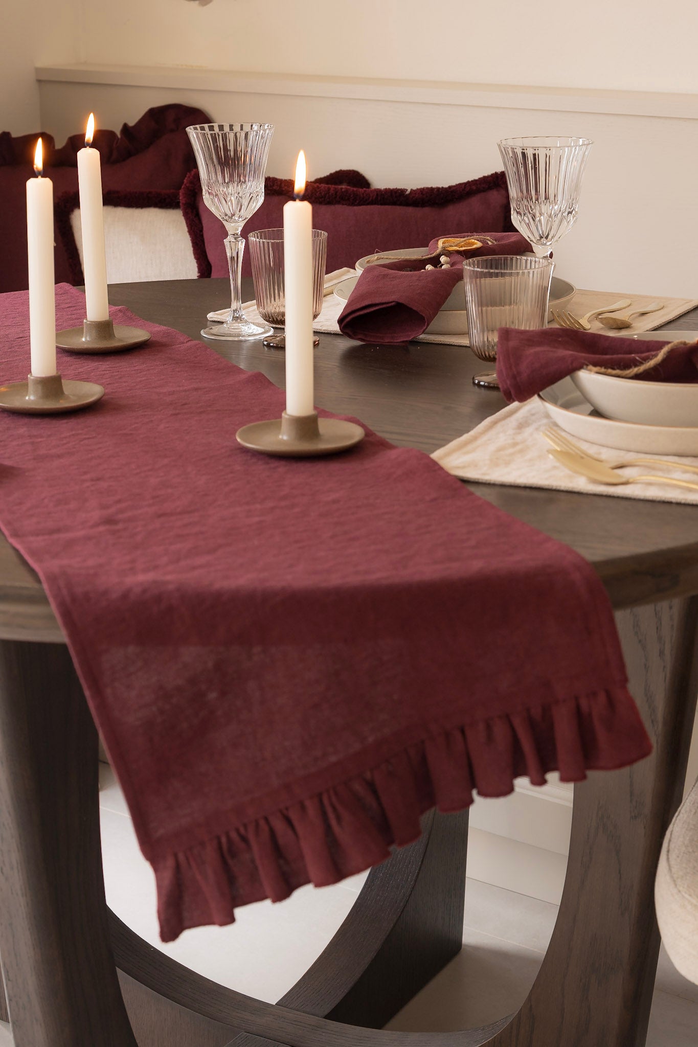 Dining table set with a burgundy table runner, candles, and glasses. 100% Irish Linen. Handmade in Ireland