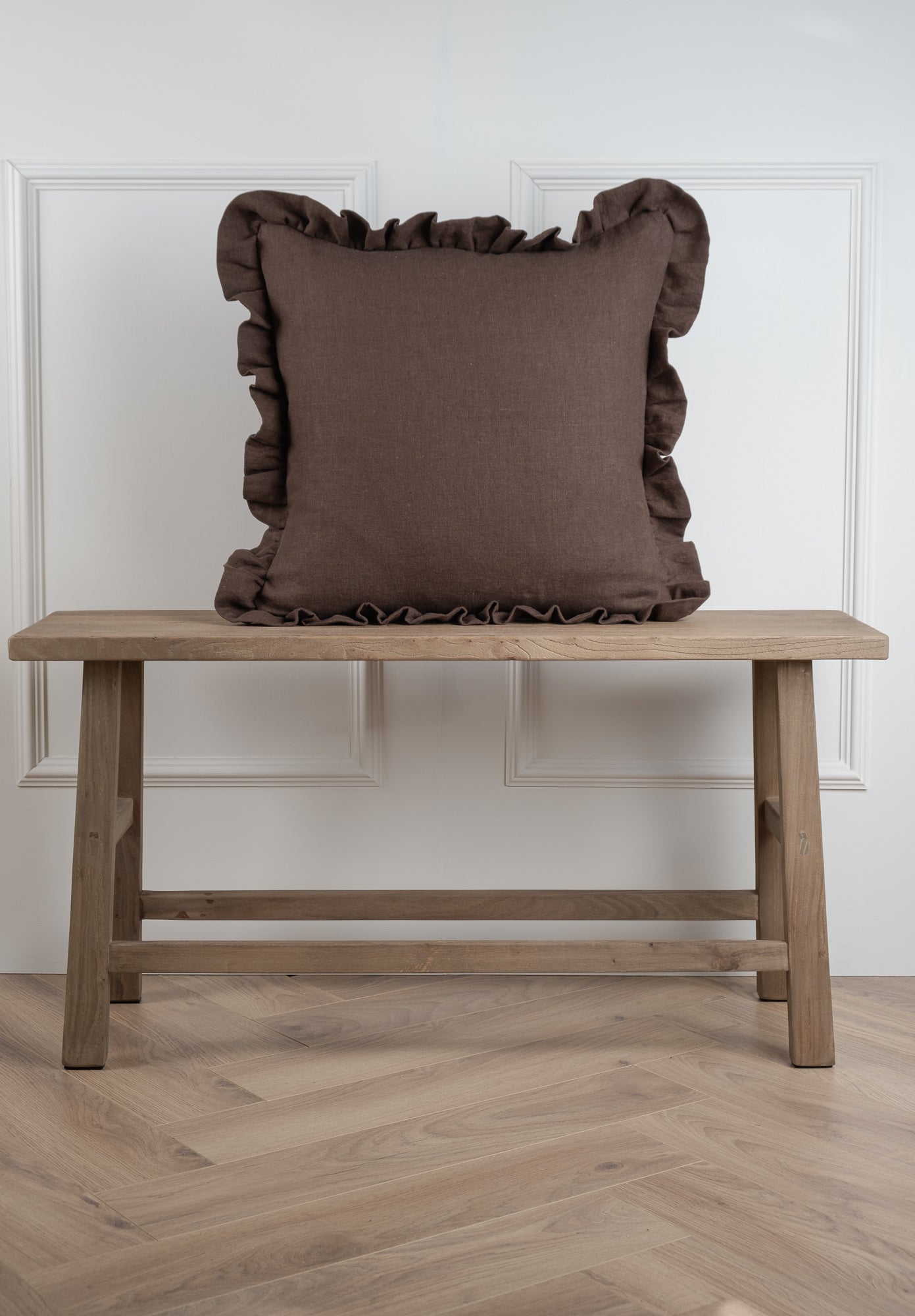 A Olive linen cushion featuring a frilled gathered edging. 100% Irish Linen, Woven and Made in Ireland. This linen has a beautiful laundered finish which leaves a beautiful textured natural finish to the cushion