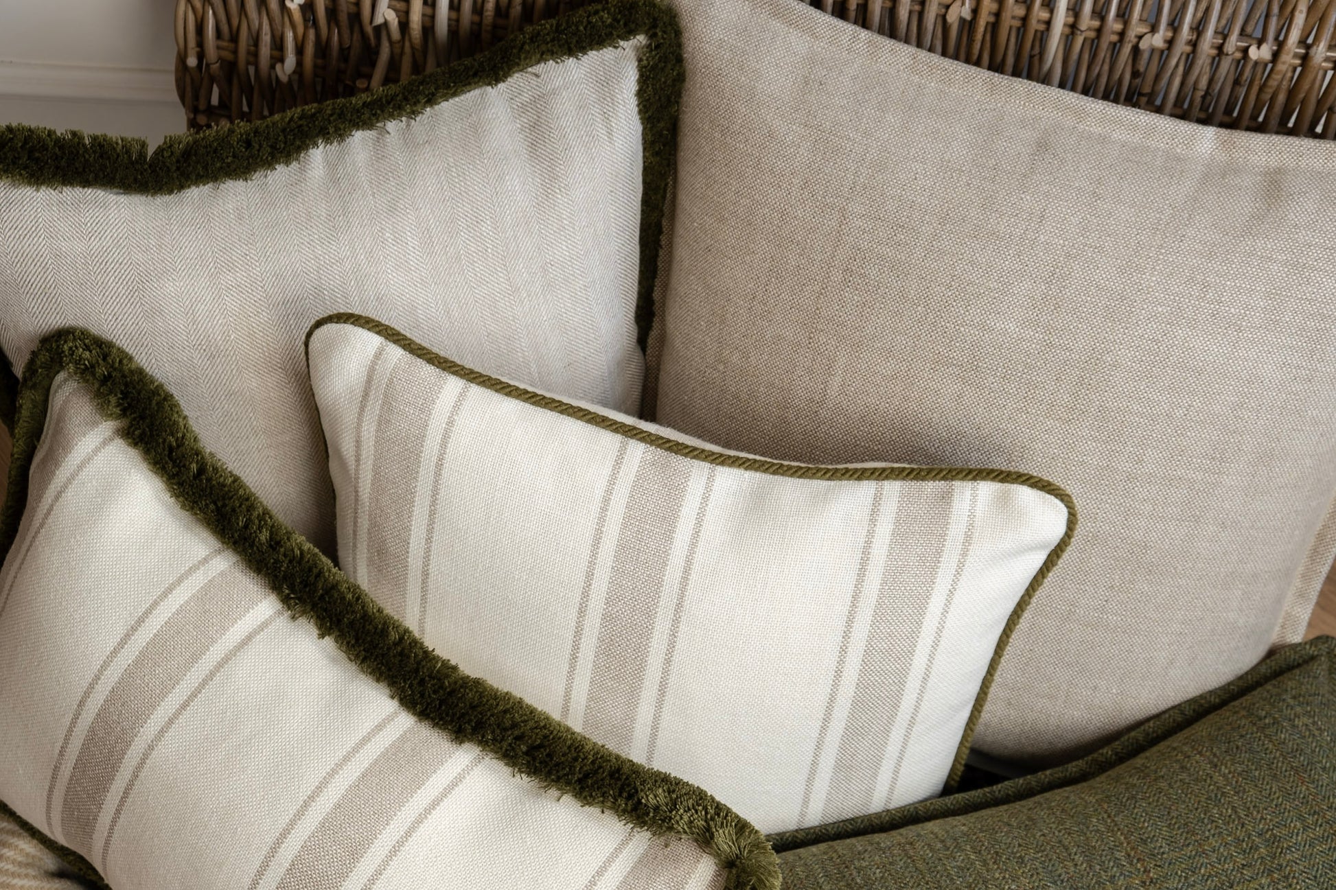 Neutral and green cushion selection. Different patterns and textures that creates dimension and interest to your space. Linens, Tweeds, Piping and fringing. 